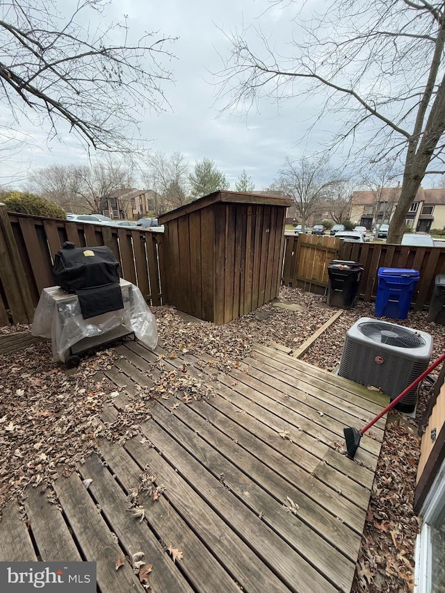 deck featuring central AC and a storage shed