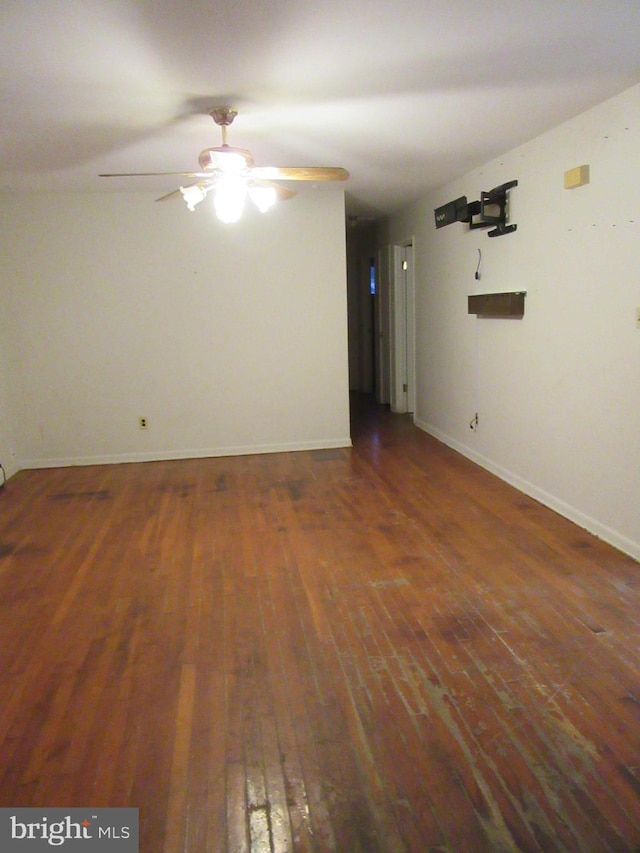 unfurnished room featuring ceiling fan and dark wood-type flooring