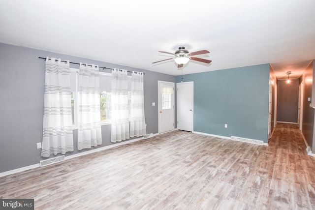 unfurnished room featuring hardwood / wood-style floors and ceiling fan