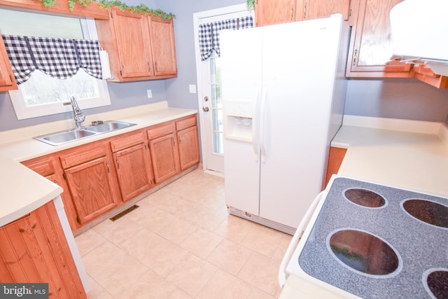 kitchen with white refrigerator with ice dispenser and sink