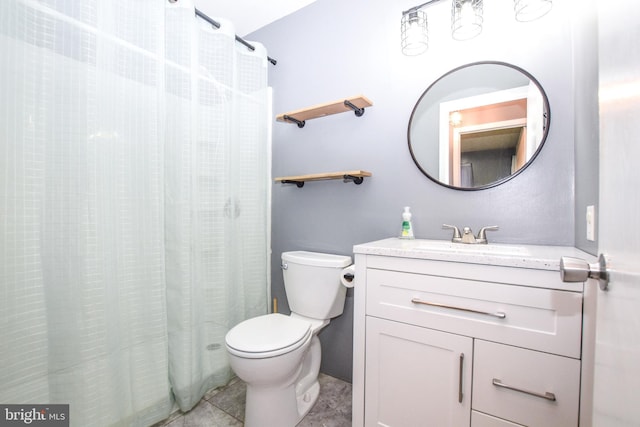 bathroom featuring tile patterned flooring, vanity, and toilet