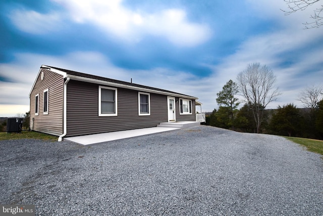 view of front of house featuring central air condition unit and a patio