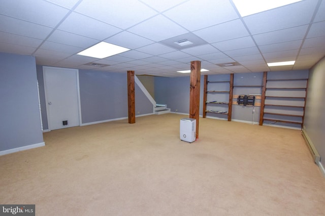 basement with carpet floors and a drop ceiling