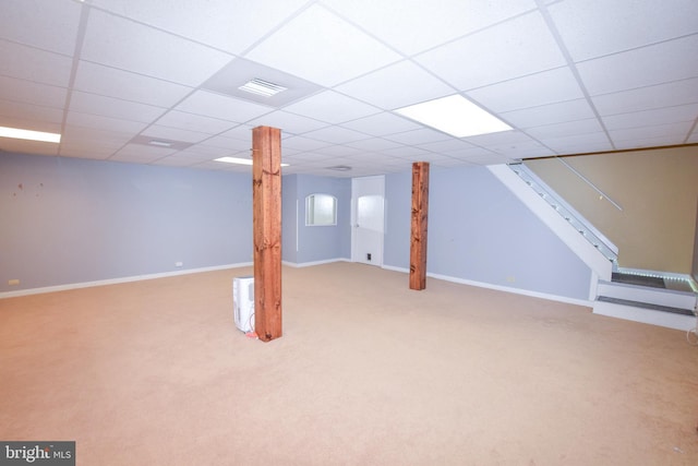 basement with light carpet and a drop ceiling