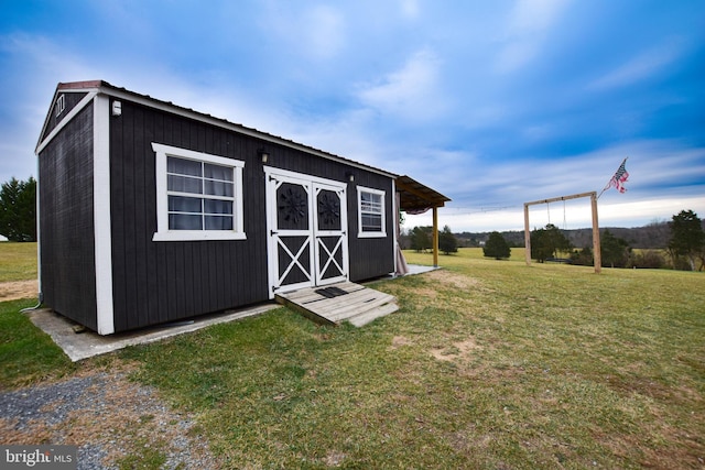 view of outbuilding with a yard