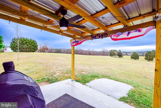 view of yard with ceiling fan, a patio, and a rural view