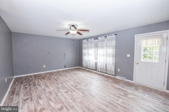 empty room featuring ceiling fan and light hardwood / wood-style flooring