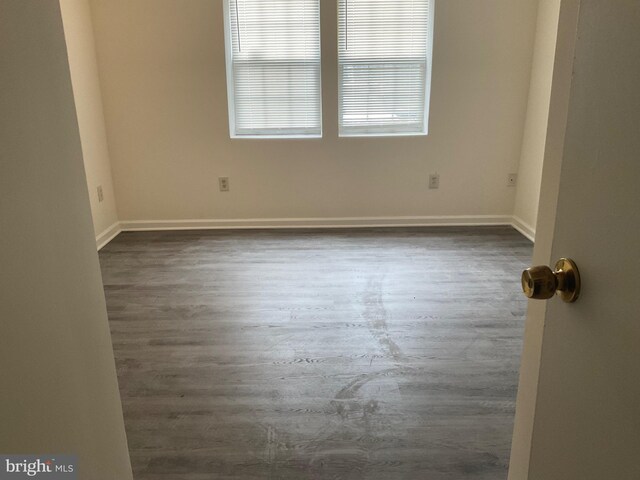 spare room featuring dark hardwood / wood-style floors