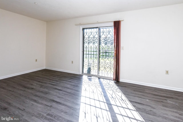 unfurnished room featuring dark hardwood / wood-style flooring