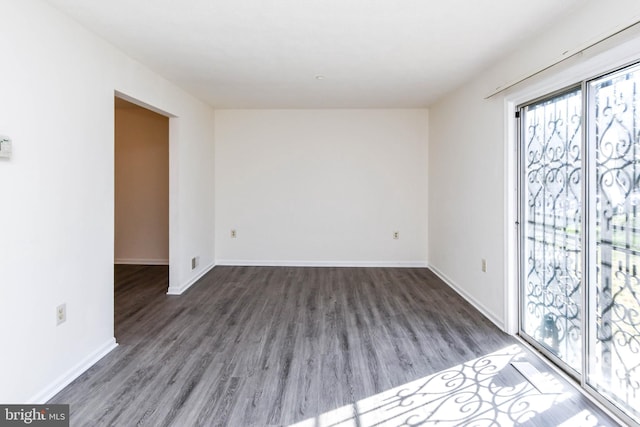 unfurnished room featuring dark hardwood / wood-style flooring