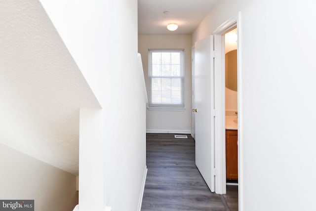 corridor featuring dark hardwood / wood-style flooring