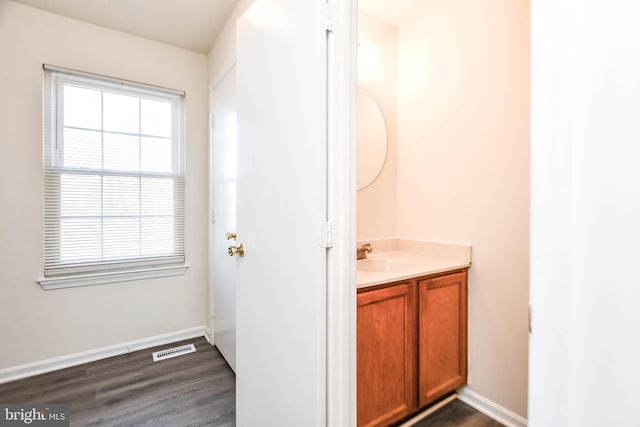 bathroom with vanity and wood-type flooring