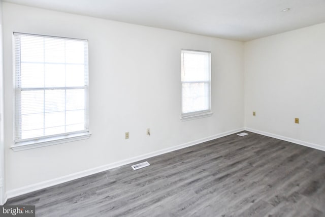 empty room with dark wood-type flooring