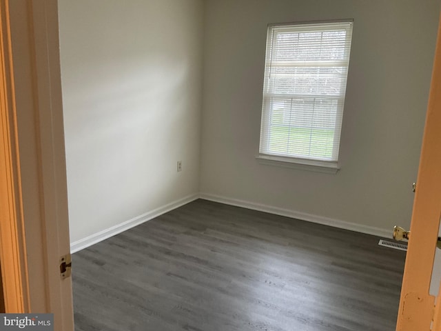 empty room featuring dark wood-type flooring