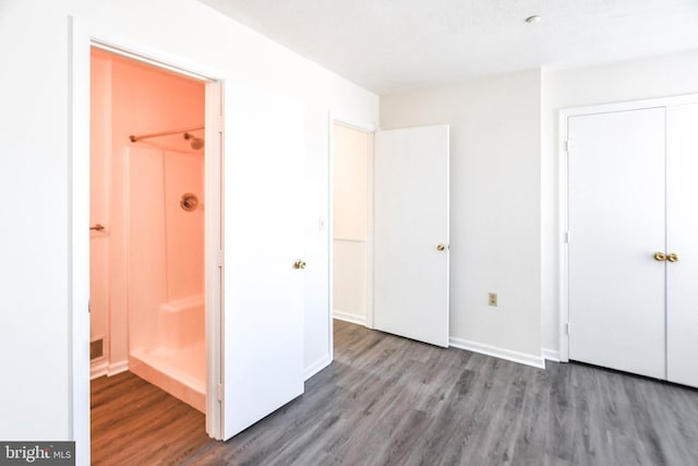 unfurnished bedroom featuring wood-type flooring and a closet