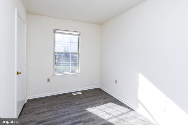 unfurnished room with dark hardwood / wood-style floors