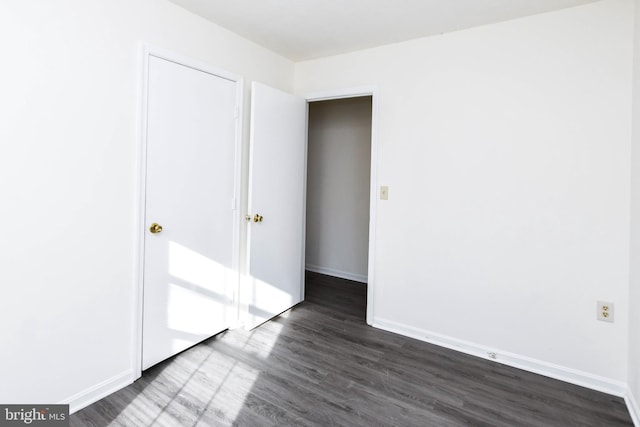 empty room with dark wood-type flooring