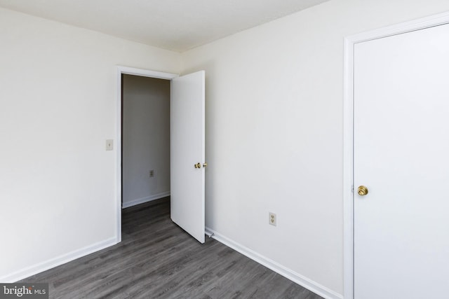 unfurnished bedroom featuring dark hardwood / wood-style flooring