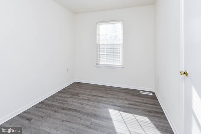 spare room with dark hardwood / wood-style floors