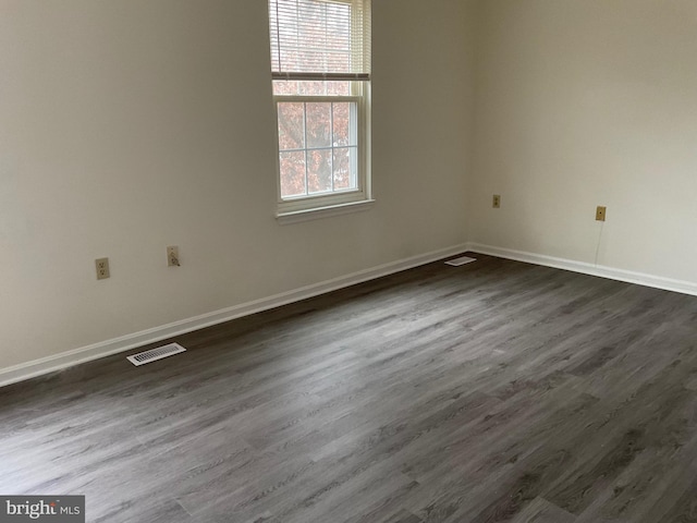 spare room featuring dark hardwood / wood-style flooring