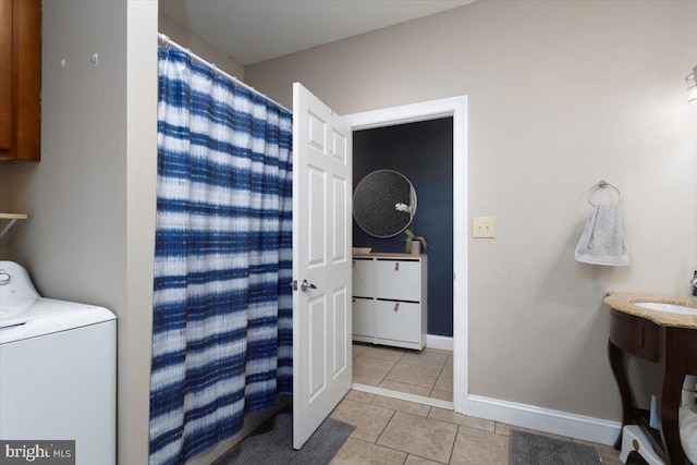 laundry room featuring light tile patterned floors and washer / clothes dryer