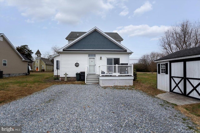 view of front of house with a storage unit and a wooden deck