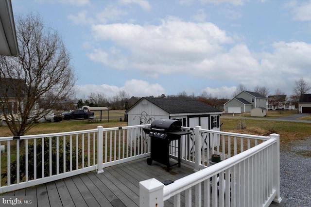 wooden terrace featuring grilling area and a shed