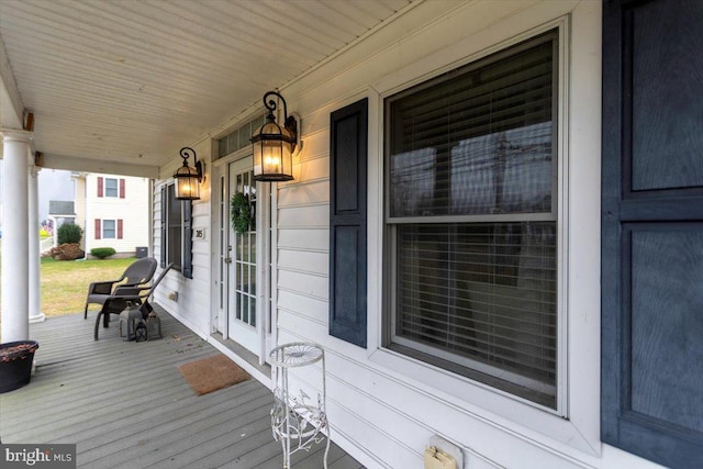 wooden terrace featuring covered porch