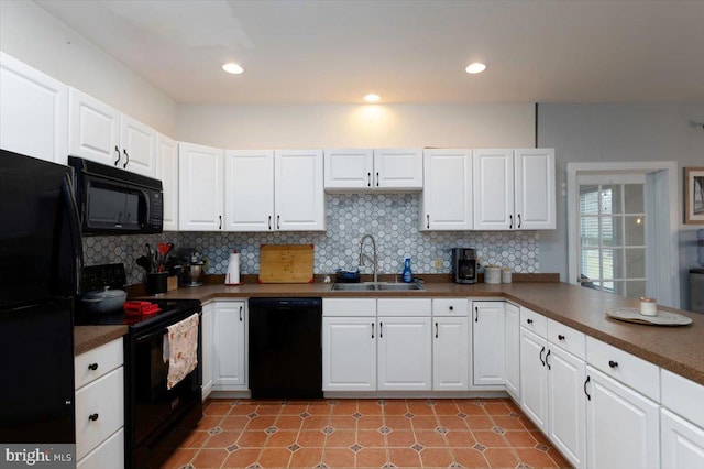 kitchen featuring black appliances, white cabinetry, and sink