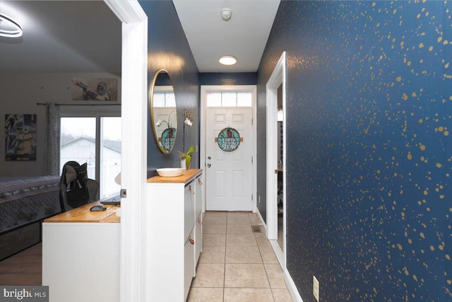 interior space with light tile patterned floors and plenty of natural light