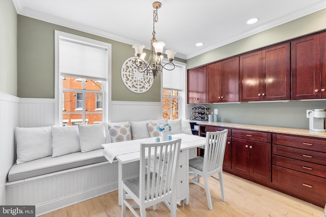 dining space featuring a chandelier, light wood-type flooring, breakfast area, and ornamental molding