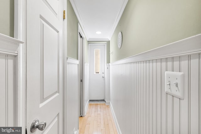 hallway featuring light hardwood / wood-style floors and ornamental molding