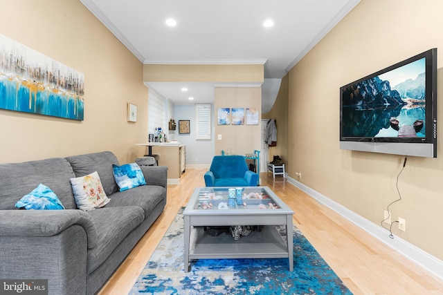 living room featuring wood-type flooring and ornamental molding