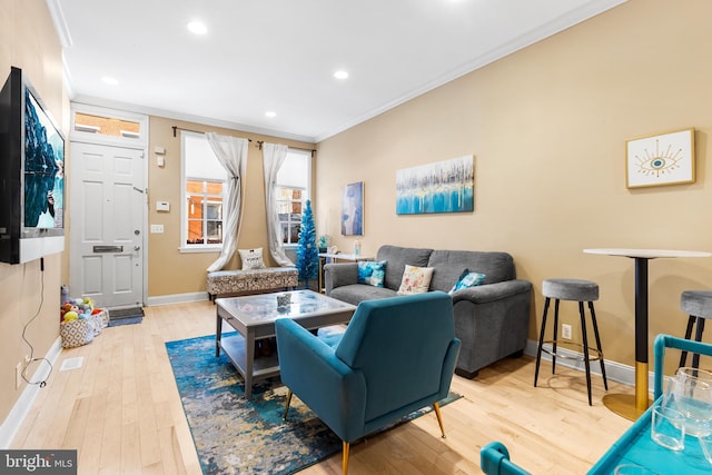 living room with wood-type flooring and ornamental molding