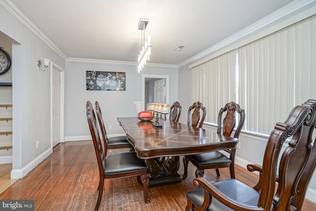 dining area featuring crown molding and hardwood / wood-style floors