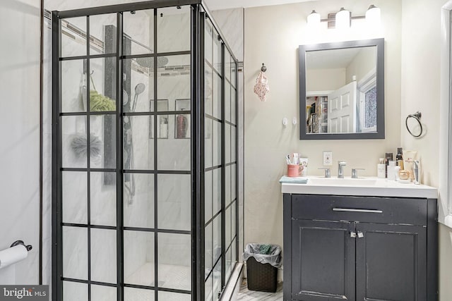 bathroom featuring a tile shower and vanity