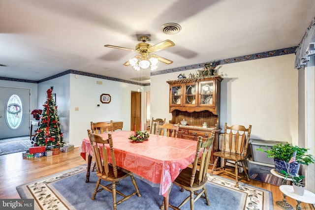 dining area with hardwood / wood-style flooring and ceiling fan