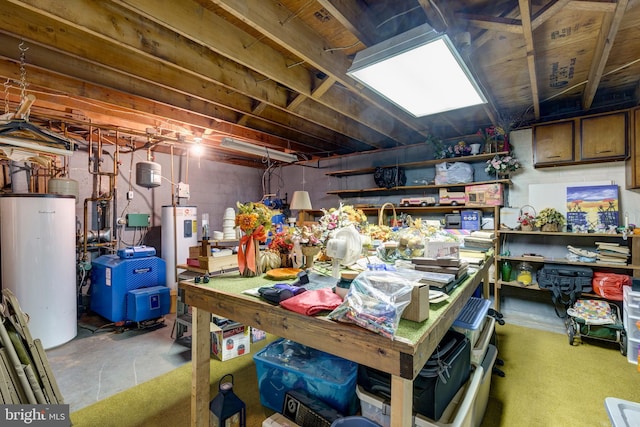 basement featuring electric water heater, a workshop area, and water heater