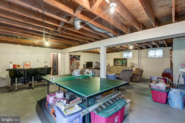 recreation room featuring concrete flooring