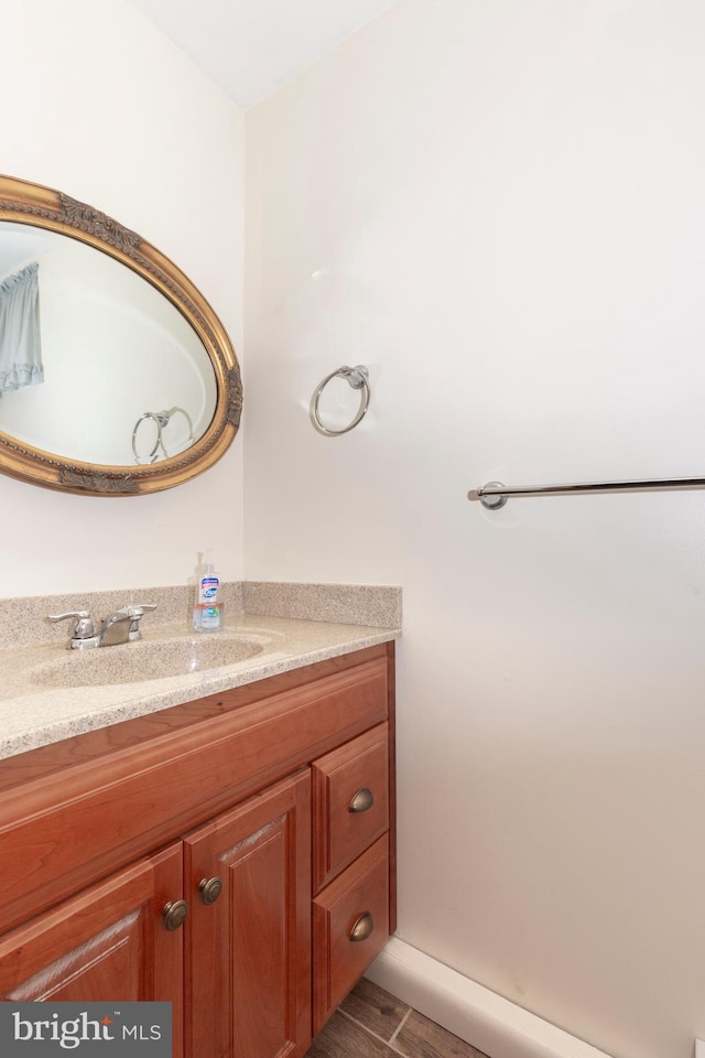 bathroom with hardwood / wood-style floors and vanity