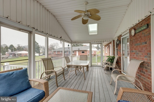 sunroom with a wealth of natural light, ceiling fan, wooden ceiling, and vaulted ceiling