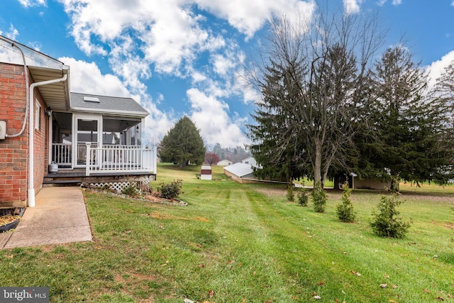 view of yard featuring a deck and a sunroom