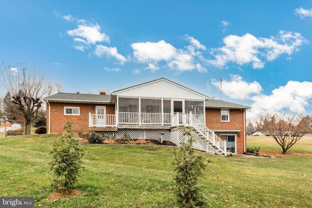 view of front of house featuring a front lawn and a sunroom