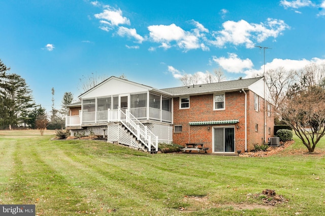 back of property with a yard, cooling unit, and a sunroom