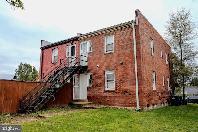 rear view of house with a yard