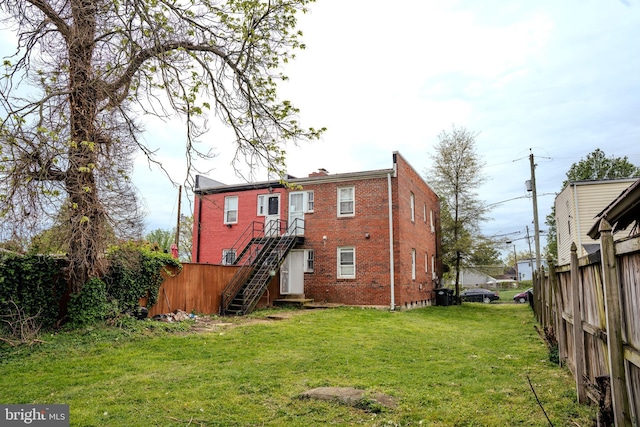 back of house with a lawn