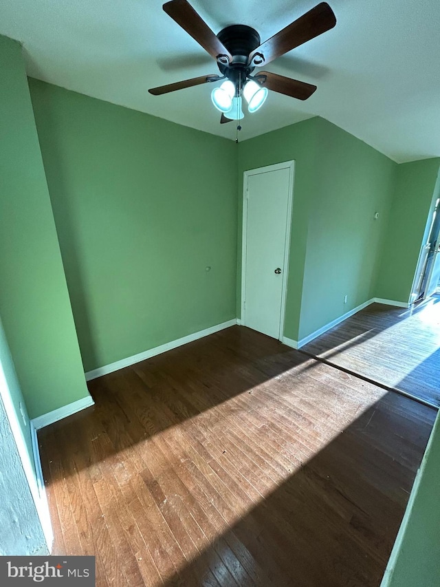 spare room featuring ceiling fan and dark hardwood / wood-style flooring