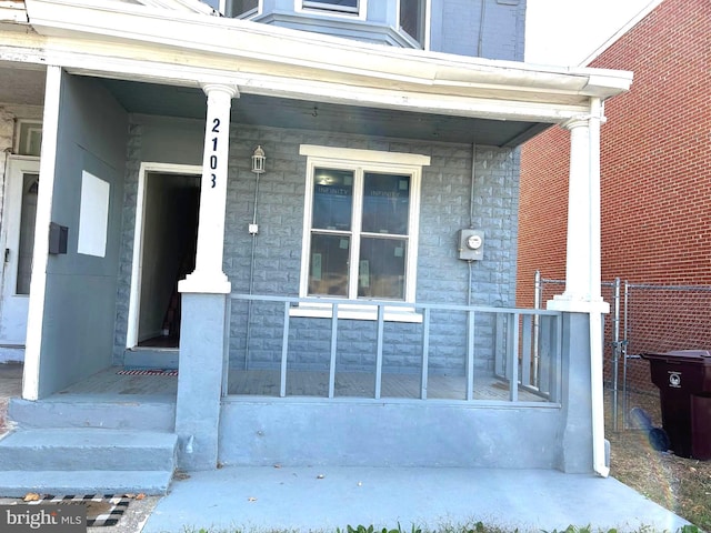 view of exterior entry with covered porch