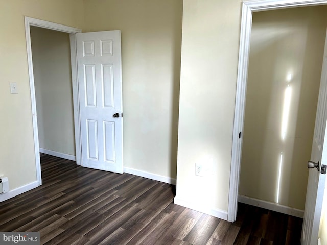 unfurnished bedroom featuring dark wood-type flooring