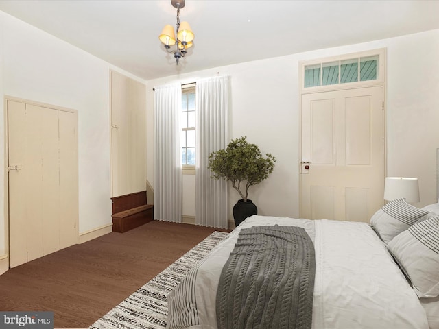 bedroom featuring dark hardwood / wood-style floors and a notable chandelier